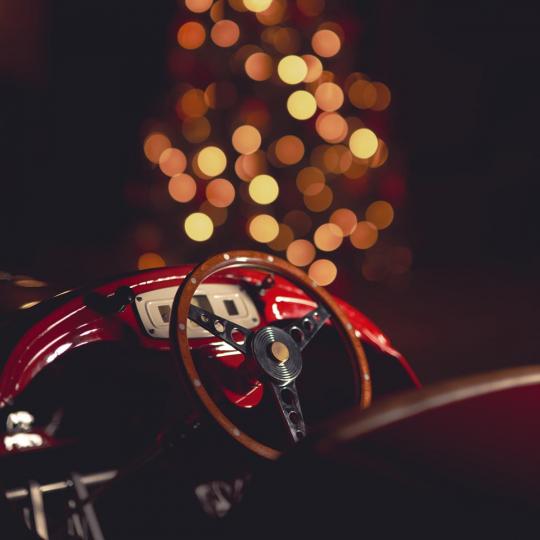 Austin J40 pedal car in front of Christmas lights